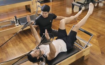Man working with male Pilates instructor in a tailored one-to-one session