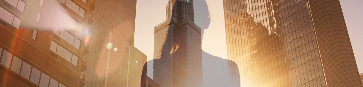 Stress Management – yoga pose in city skyscape Shadow of a woman in a yoga pose looking out across a big city and skyscrapers