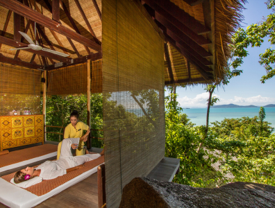 Spa Retreat in Asia – Traditional Massage with Scenic View Man overlooking nature while receiving a traditional massage treatment at a spa retreat in Asia