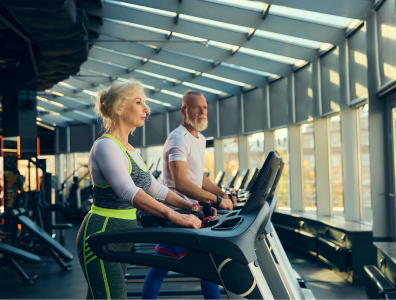 Woman exercising with a male personal trainer during a gym fitness session on a bespoke fitness holiday