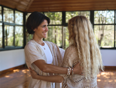 Emotional Healing Retreat – Supportive Conversation in Peaceful setting Two women engaged in conversation in a tranquil setting at an emotional healing retreat