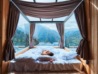 Sleep Retreats - for deep Rest and Relaxation Woman getting a deep sleep in front of a peaceful natural view
