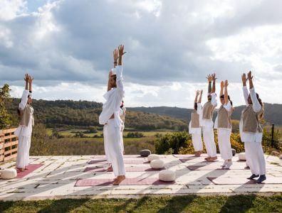 Group participating in an outdoor Ayurveda stretching session in Europe