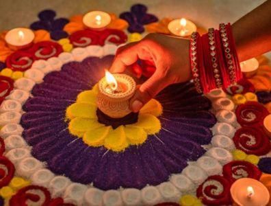 Indian lady surrounded by candles and a circle of flowers during an Ayurveda ritual in India