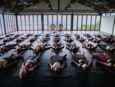 Group yoga session at a retreat with participants in resting position