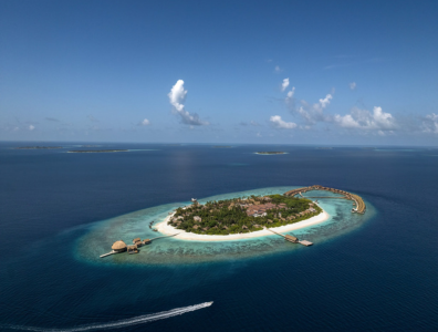 Tropical island surrounded by white sand and water villas