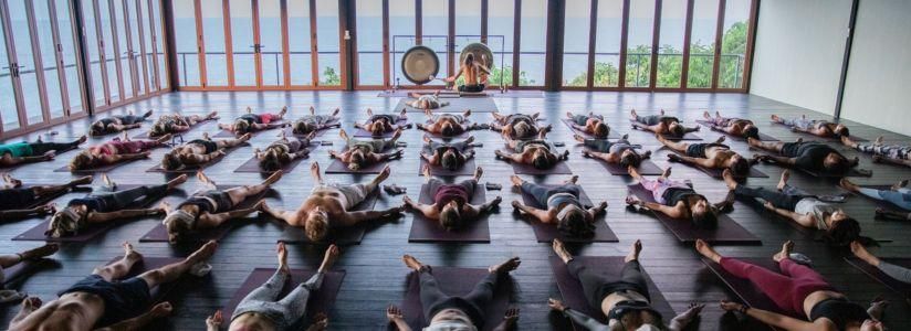 Group yoga session at a retreat with participants in resting position
