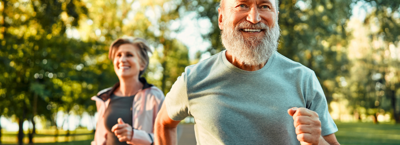 Person running along a palm-lined beach at sunset 
