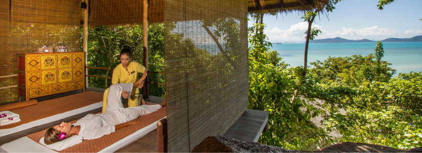Spa Retreat in Asia – Traditional Massage with Scenic View Man overlooking nature while receiving a traditional massage treatment at a spa retreat in Asia