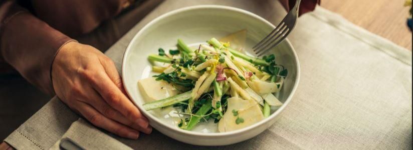 Man enjoying a healthy vegan meal prepared by a nutritionist at a retreat