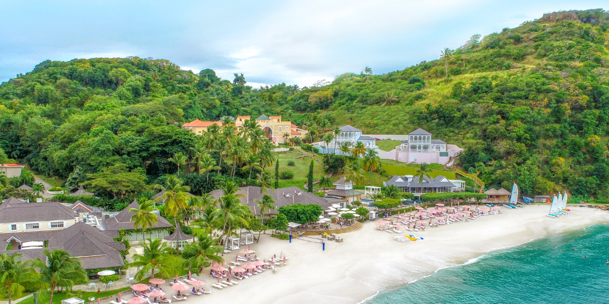 Beachfront view of Body Holiday resort in Saint Lucia, Caribbean, with golden sand and turquoise sea