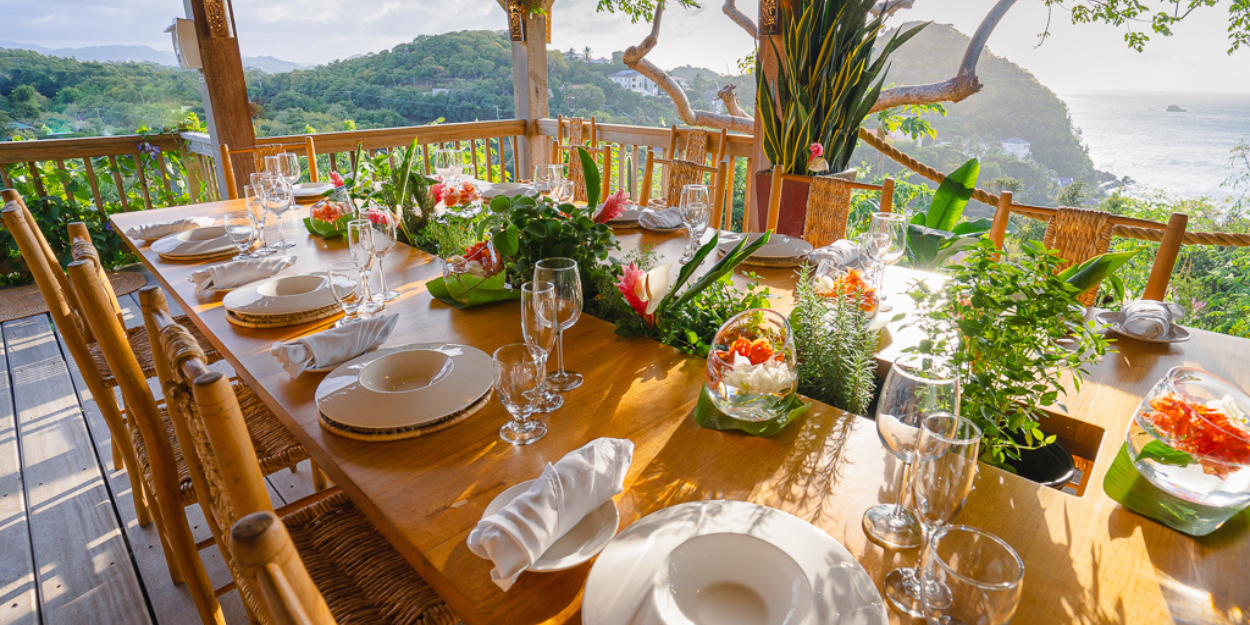 Open-air dining terrace at BodyHoliday St Lucia overlooking tropical hills and Caribbean Sea