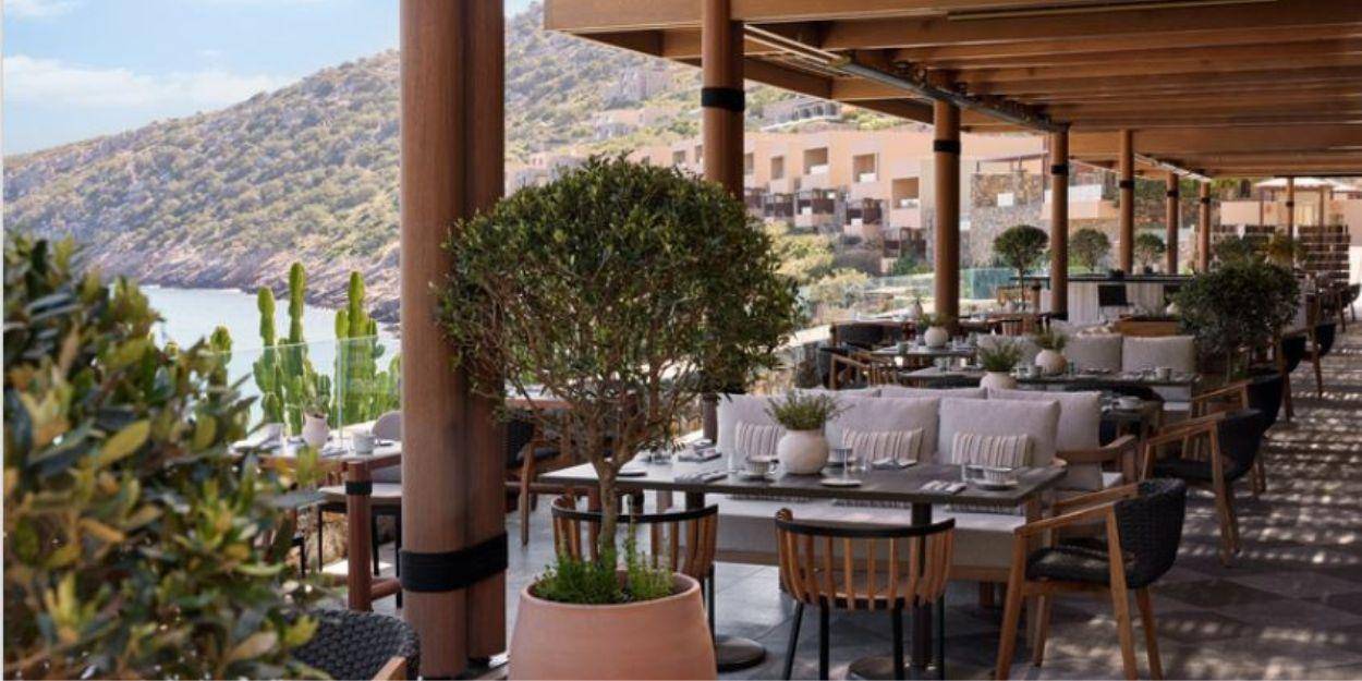 Taverna at Daios Cove Smart looking restaurant with outdoor seating overlooking the beach and mountain