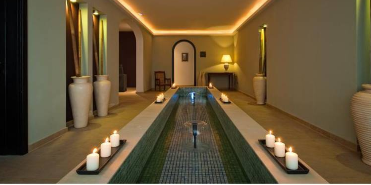 Tranquil spa treatment room at Hacienda del Conde, Tenerife, softly lit with glowing candles creating a serene ambiance