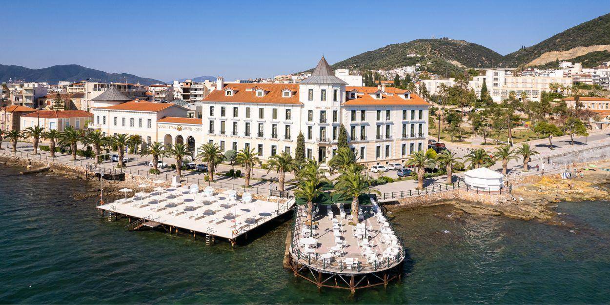 Hotel exterior with white walls and terracotta rooftops overlooking the sea