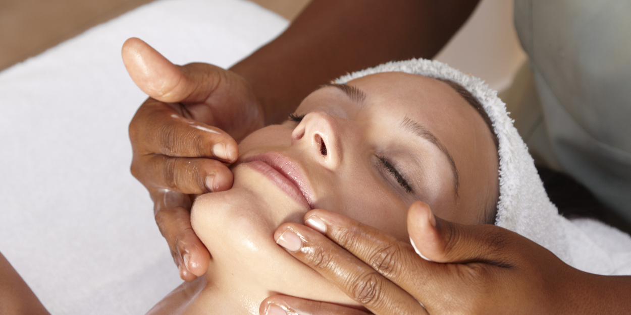 Woman receiving a relaxing facial treatment at Body Holiday spa.