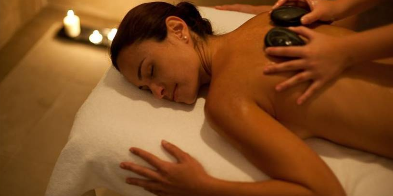 Woman receiving a relaxing hot stone massage at the spa of Hacienda del Conde, Tenerife