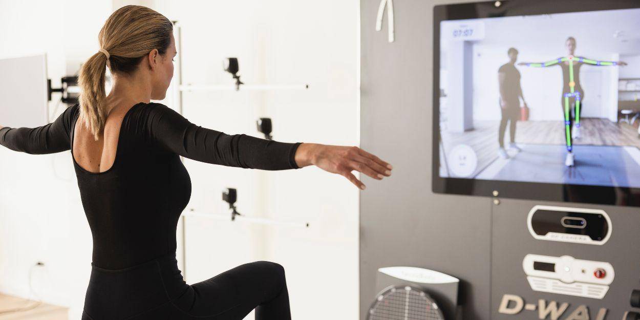 Female having her postural analysis done by using a hi-tech machine 