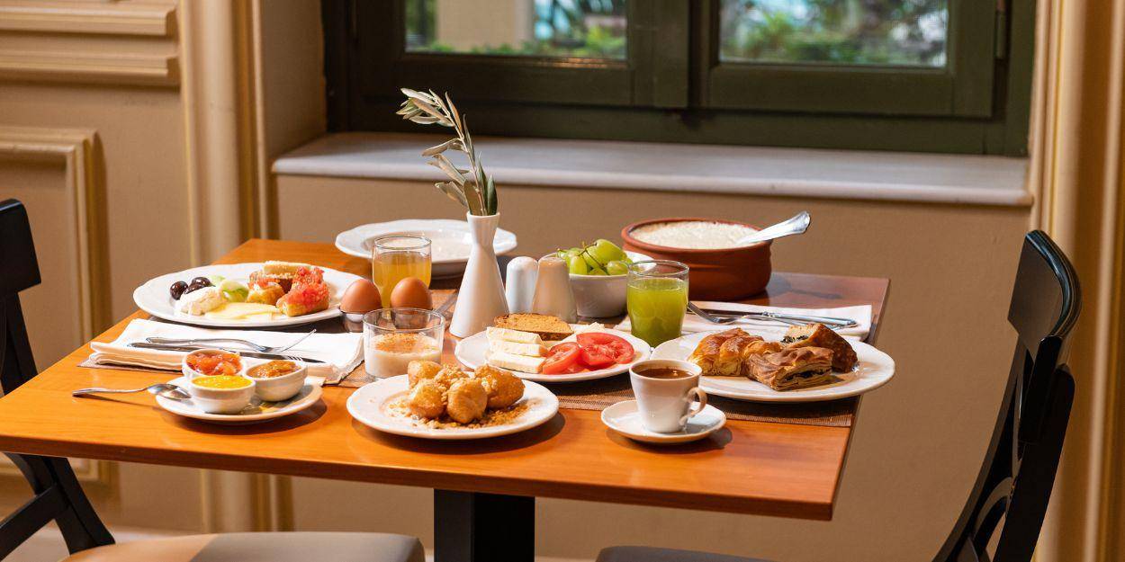 Restaurant table set for breakfast with various breakfast items 