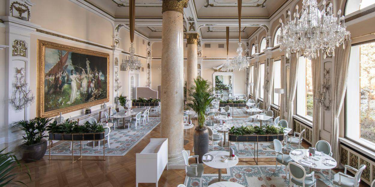 Newly refurbished restaurant with grand glittering chandelier and dinner set up