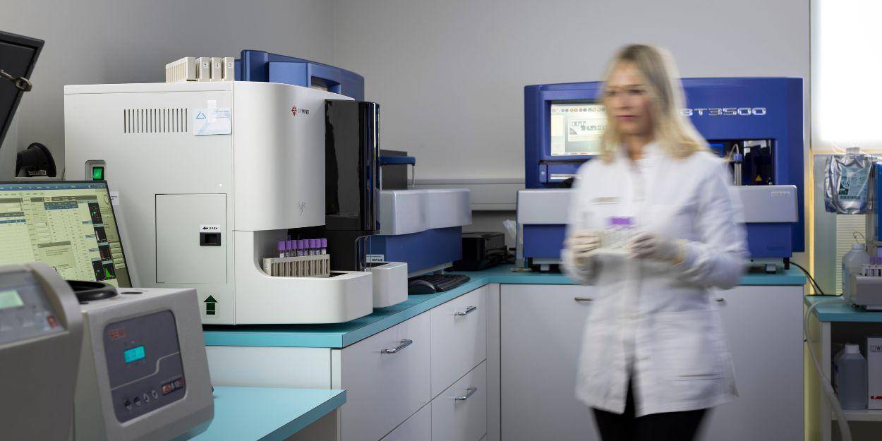 A female laboratory assistant doing tests in Palace Merano medical laboratory 