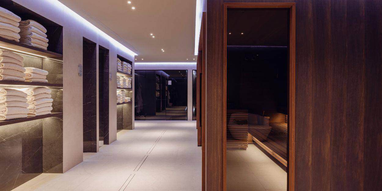 Indoor spa facilities featuring sauna and racks with clean towels 