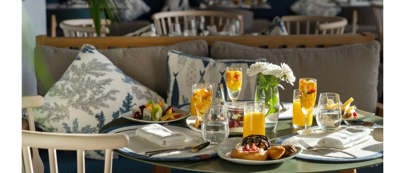 Pastries, orange juice and mimosas laid out on a table 