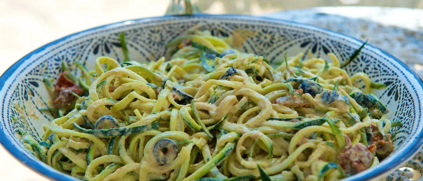 Bowl of pasta with green vegetables in a china bowl