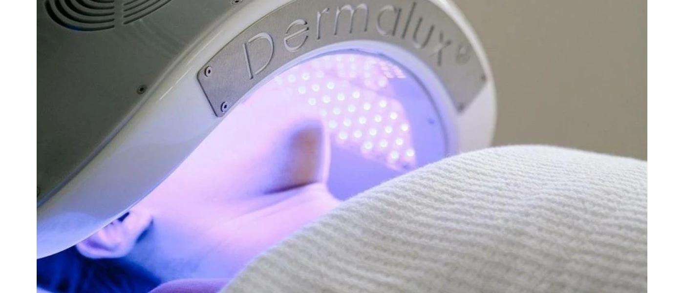 Person under a facial machine omitting light