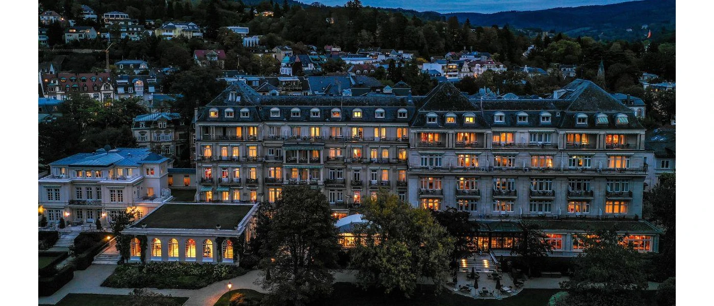 Brenners-Park Hotel & Spa mansion exterior, with multiple storeys and surrounding gardens under a darkening sky