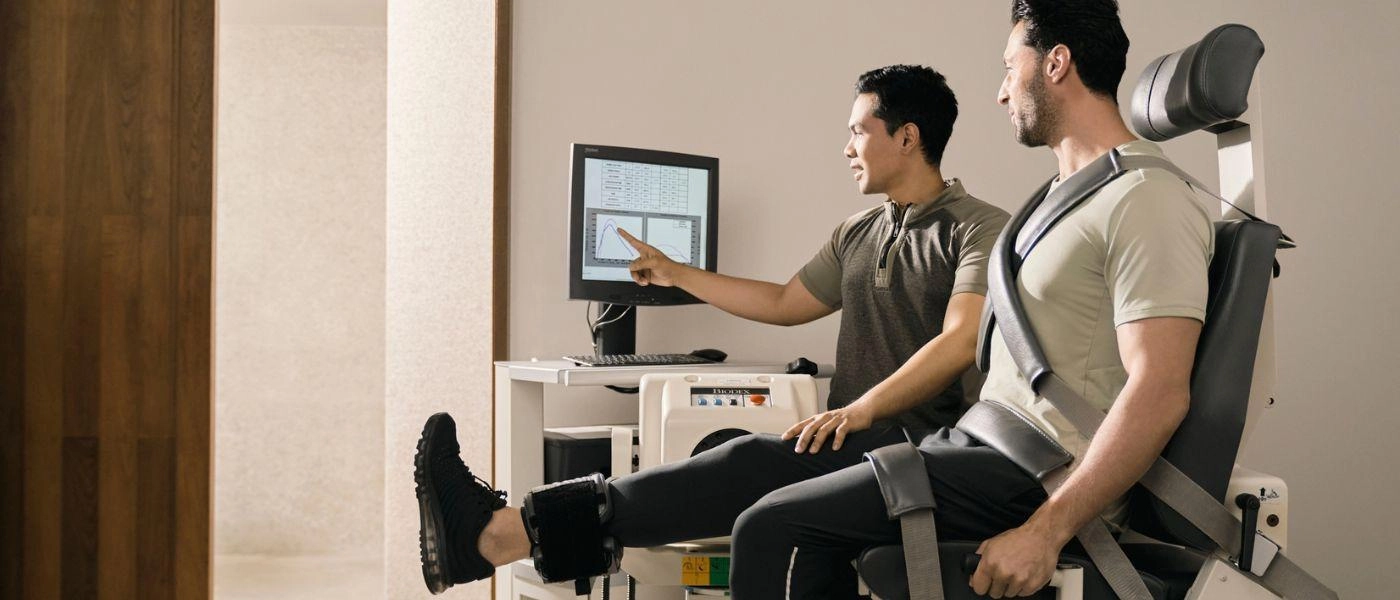 Man is having a body consultation with a wellness specialist checking his findings on a screen