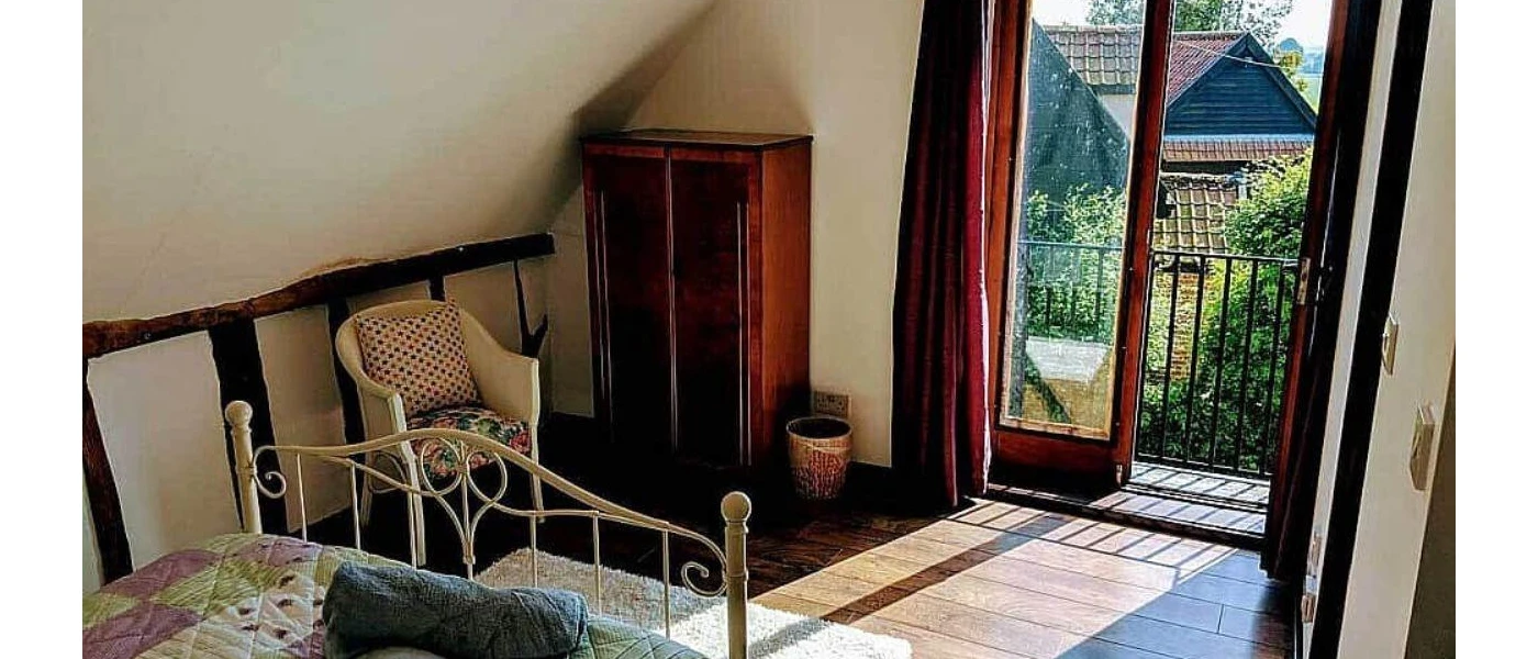 Bedroom with vintage furniture and a view of the sunny garden