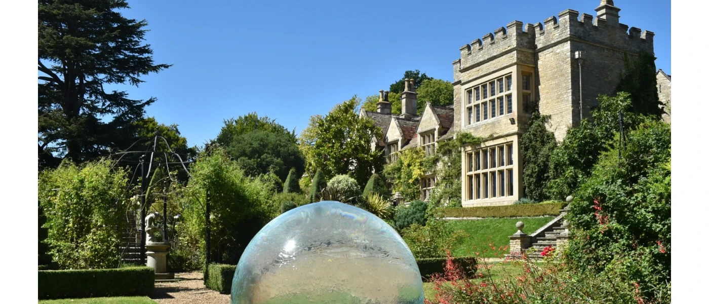 Traditional manor house in green grounds, overlooking a clear dome