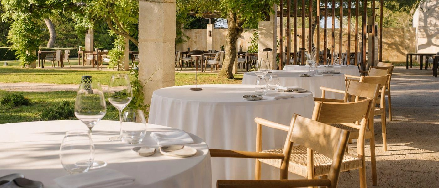 Garden dining terrace with tables dresses for smart evening meal