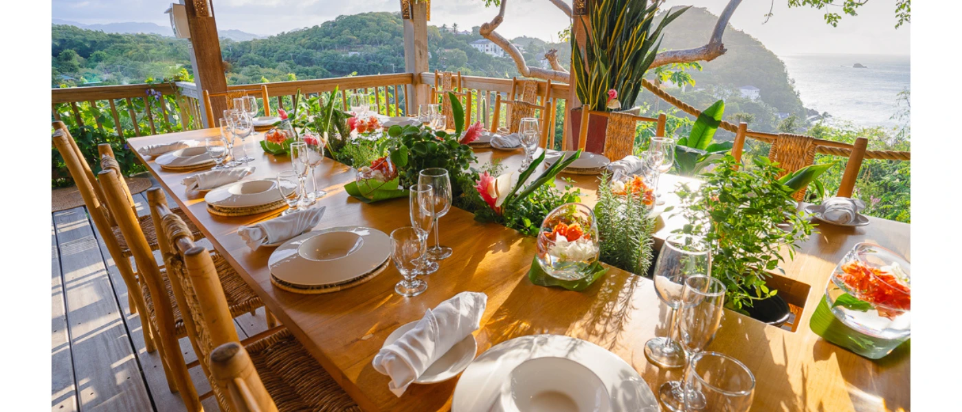 Open-air dining terrace at BodyHoliday St Lucia overlooking tropical hills and Caribbean Sea
