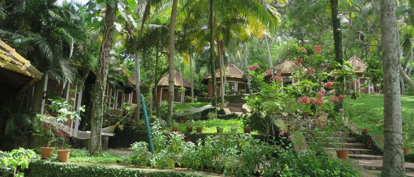 Tropical gardens with wooden huts, hammocks and terracotta plant pots