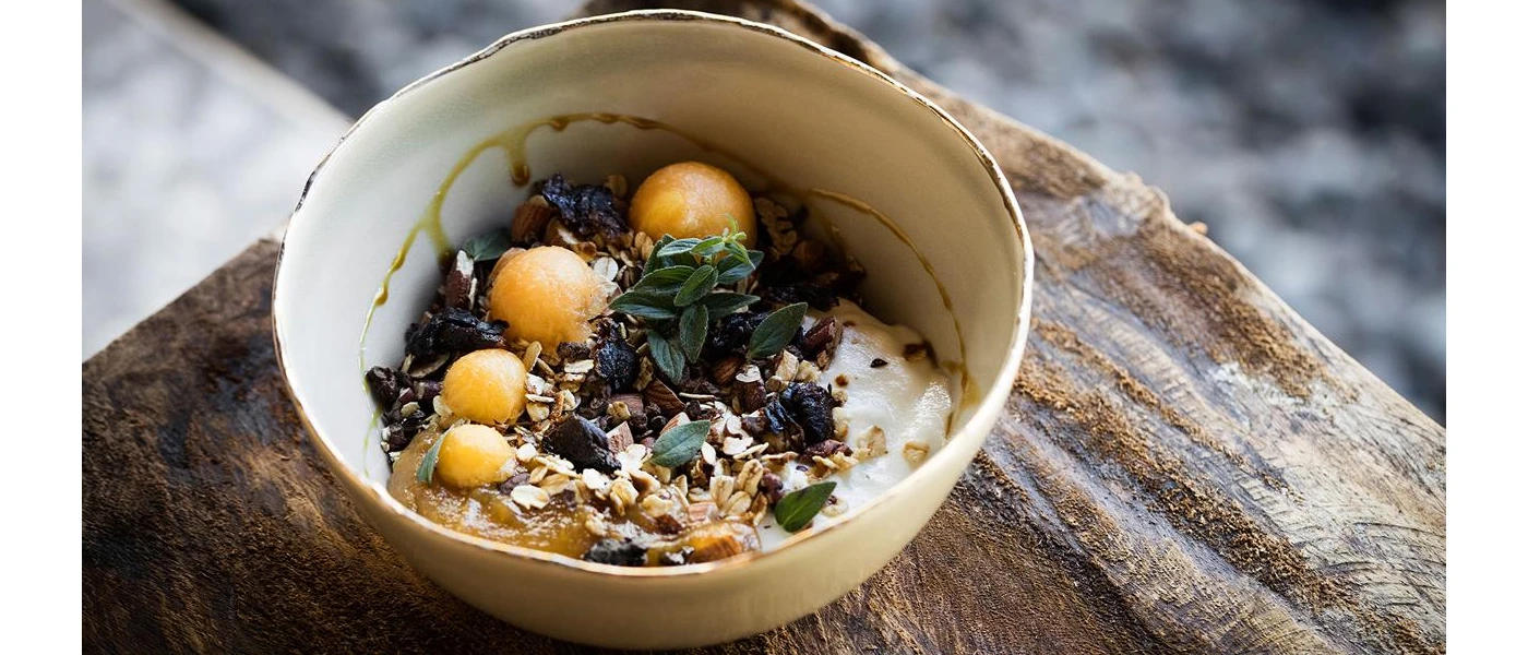 Bowl of healthy looking food, with grains, fruit and yoghurt