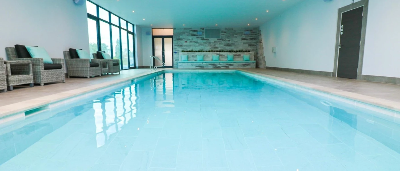 Indoor swimming pool with floor-to-ceiling windows