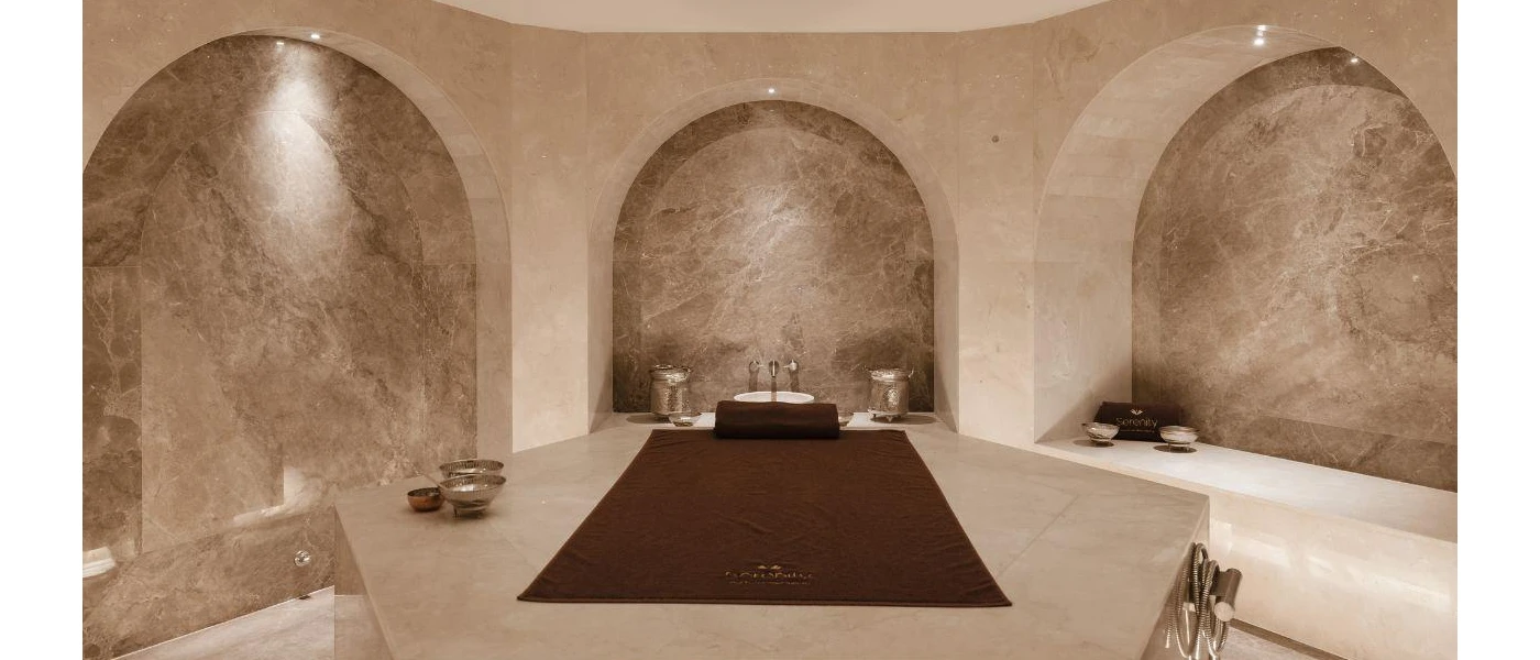 Cave-like room with marble-like walls and a set-up for Turkish bath in a central area