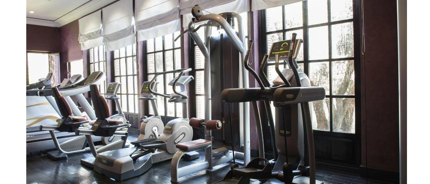 Gym equipment in a studio with large windows