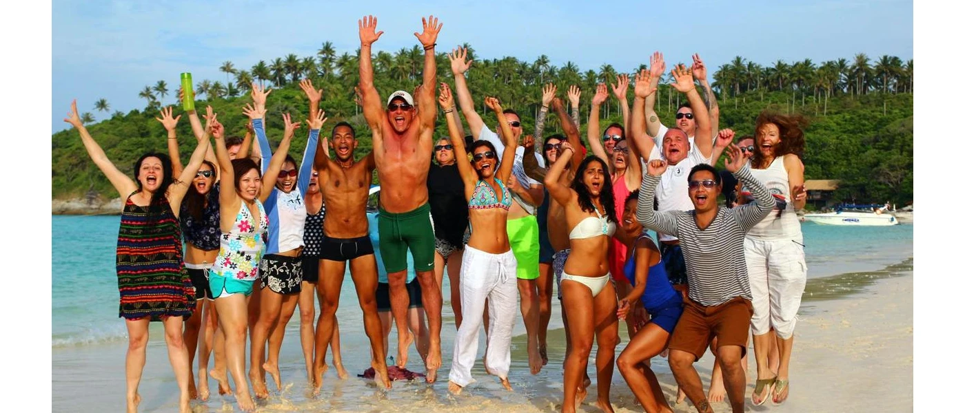 Group on a lakeside jump and smile for a photo