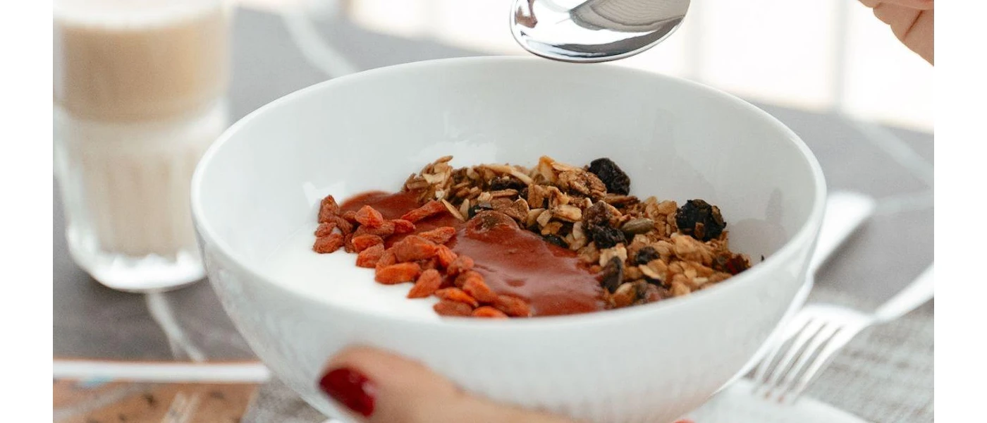 White bowl with yoghurt grains and a red sauce