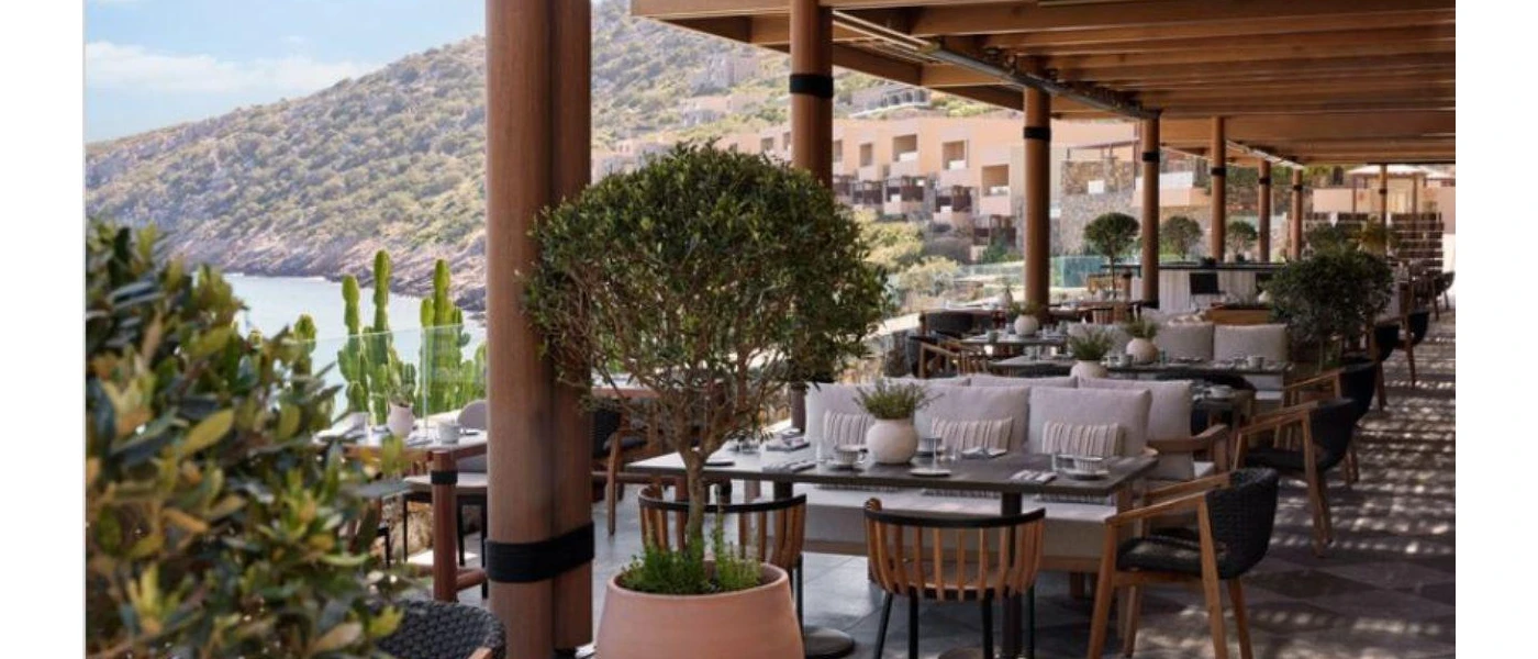 Smart looking restaurant with outdoor seating overlooking the beach and mountain 