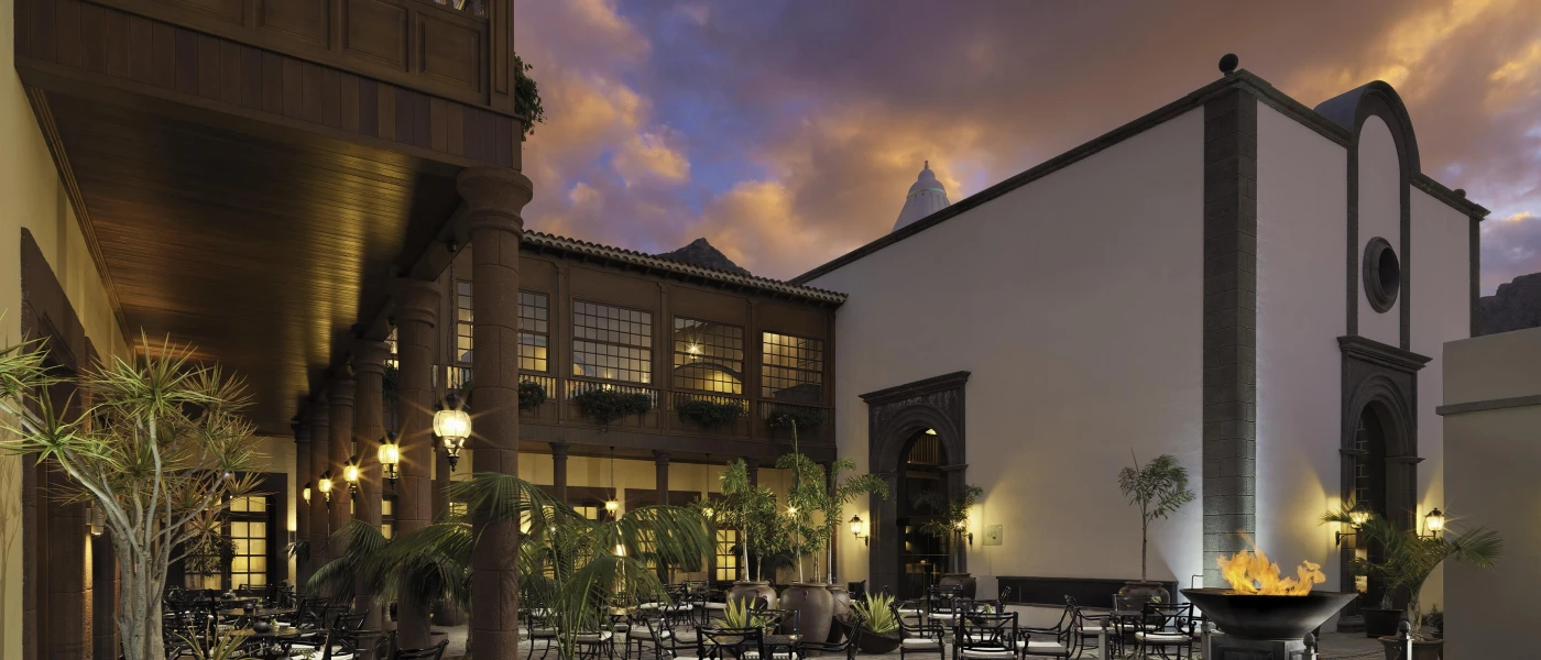 Illuminated exterior of Hacienda del Conde at night, showcasing warm lighting and traditional Spanish architecture in Tenerife
