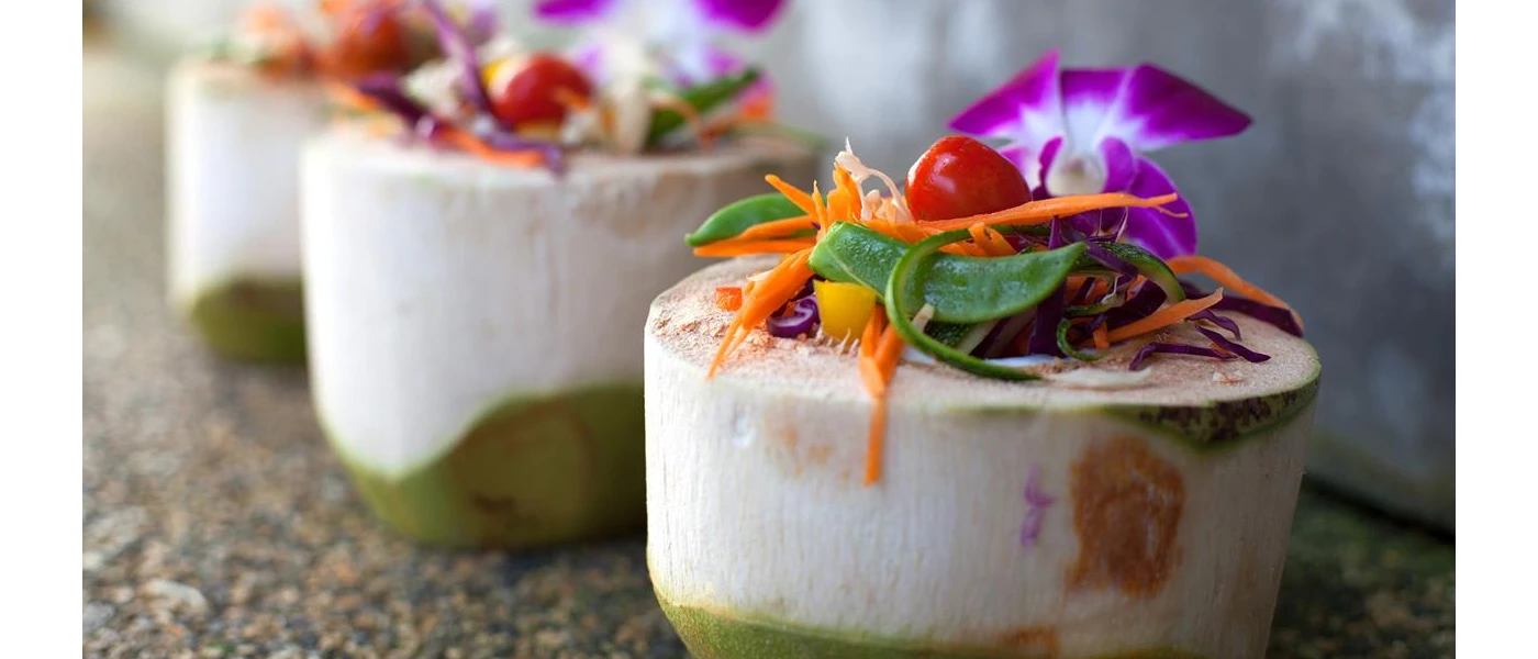 White mounds topped with vegetables and purple edible flowers