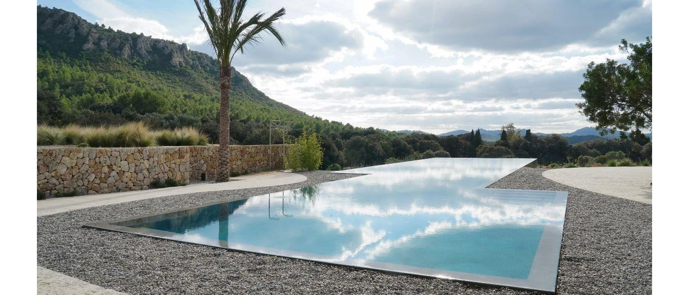 Outdoor swimming pool with an infinity edge and a view of the surrounding countryside