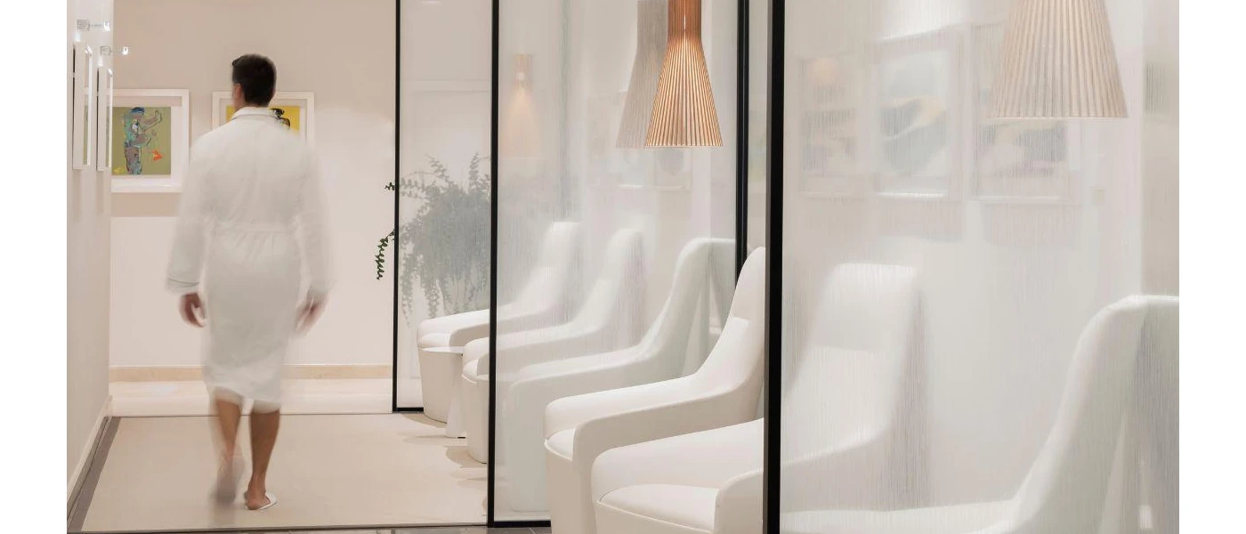 A male guest walking around spa corridor going to his treatment 