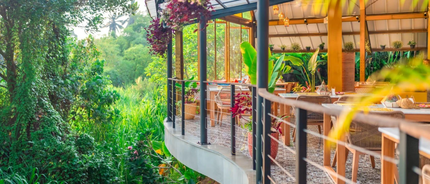 Elevated restaurant terrace suspended among tropical greenery