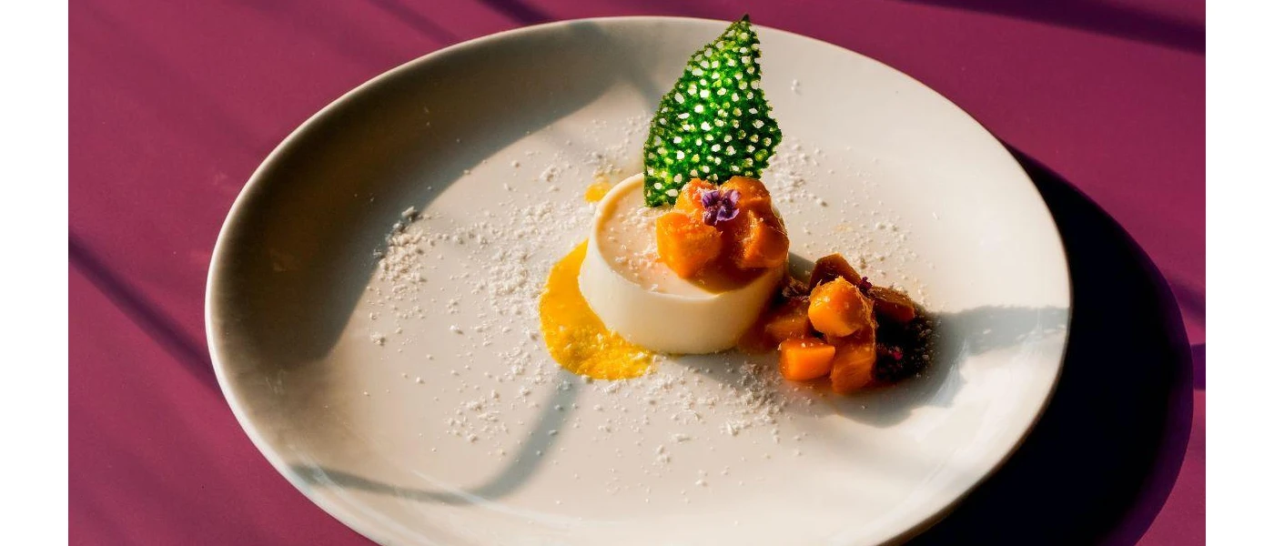 Small round dessert with fruit on a side