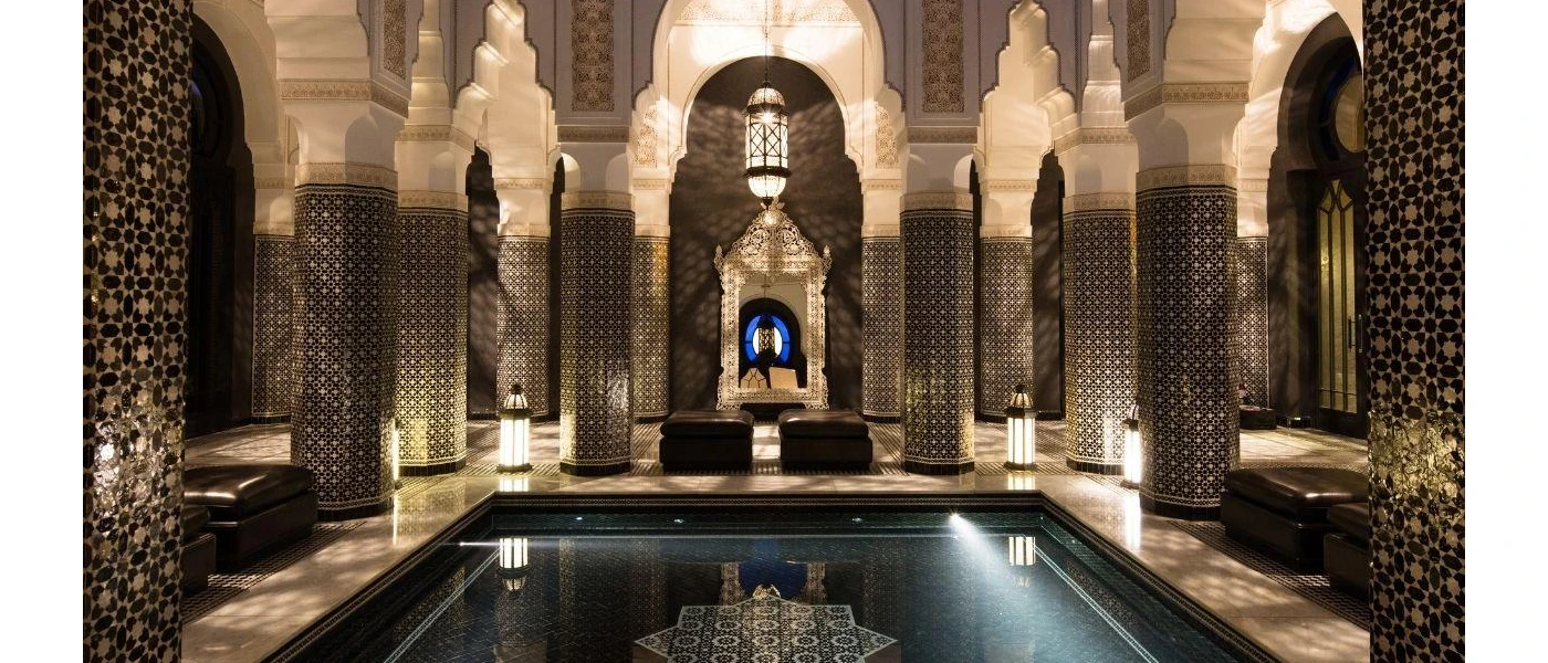 Indoor pool surrounded by decadent Arabian-style archways 